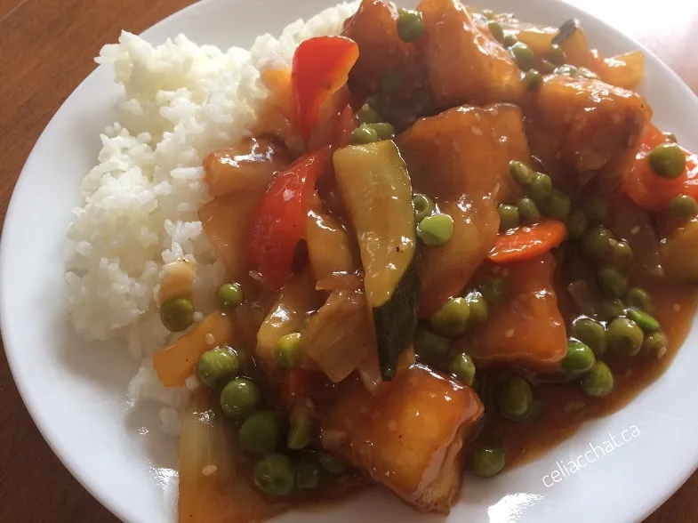 close up photo of gluten-free sweet and sour sauce with tofu and vegetables on rice